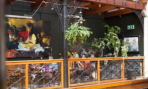 Diners on the balcony area of the Farmgate Cafe in the English Market in Cork city 